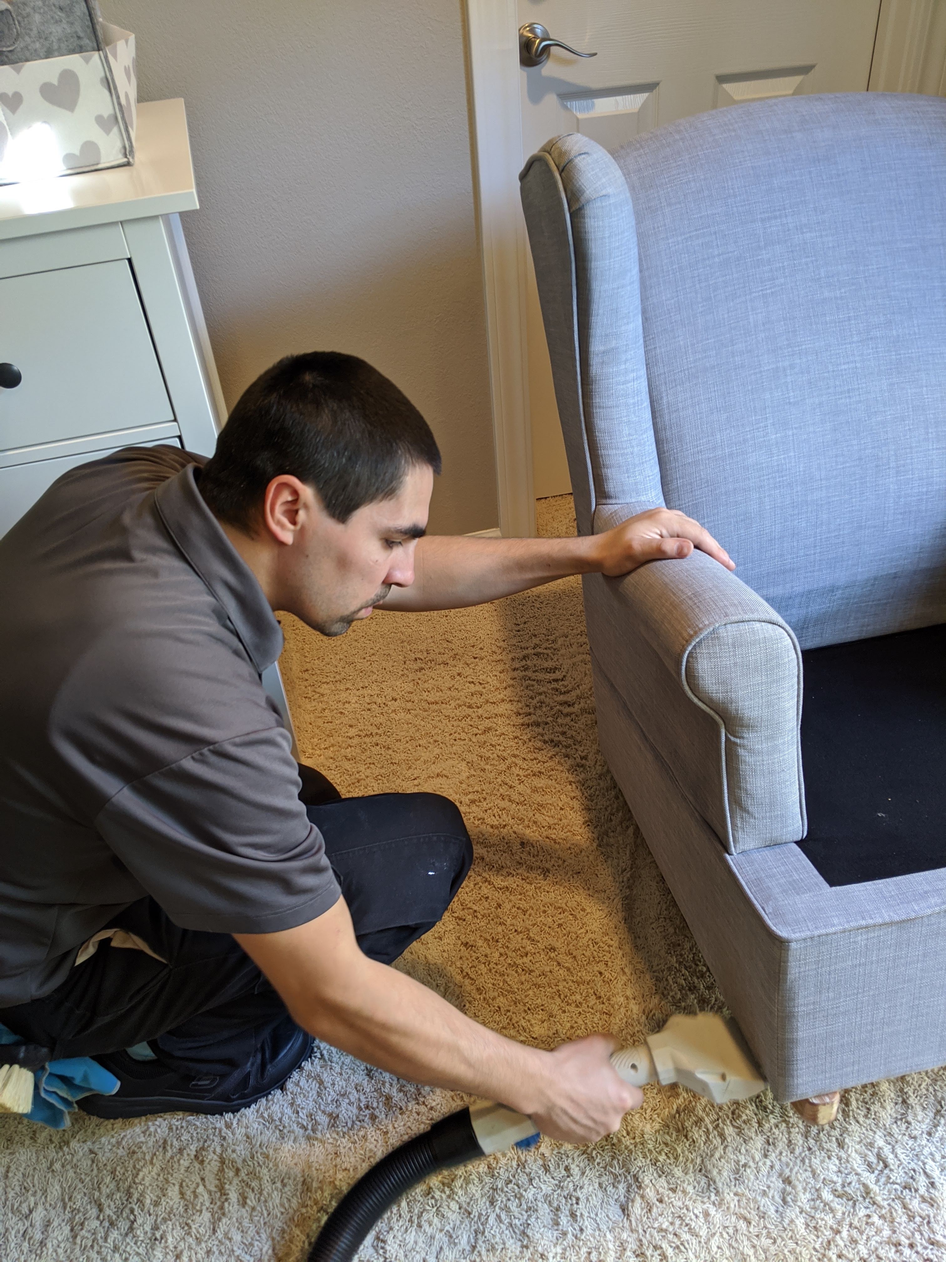 Technician cleaning an upholstery chair